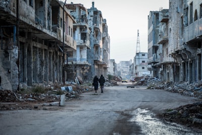 A couple of people walking down at Syria