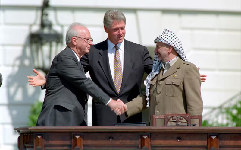Then-Israeli Prime Minister Yitzhak Rabin shakes hands with PLO leader Yasser Arafat, as U.S. President Bill Clinton looks on. Photo: Archive